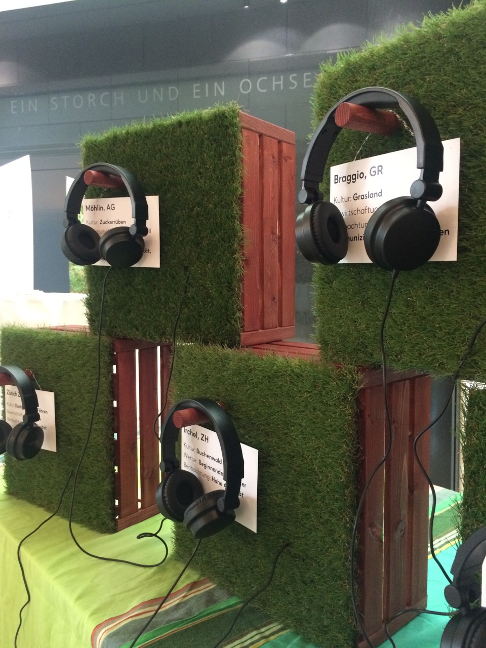 The mobile listening station consists of wooden boxes with headphones.